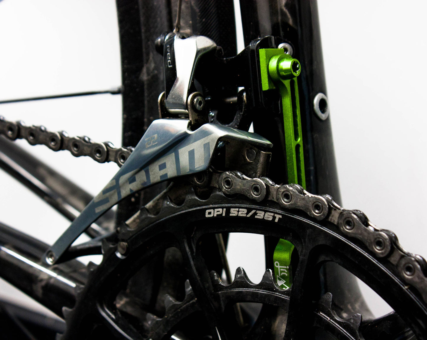 Acid green, lightweight aluminium bicycle chain catcher kit with alloy mounting bolts and braze-clamp spacer, fitted to chain system