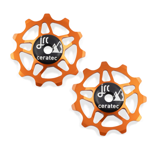 Orange, lightweight aluminium 11 tooth pulley wheel set for bicycle, compatible with Shimano 12 speed road derailleurs