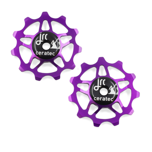 Purple, lightweight aluminium 11 tooth pulley wheel set for bicycle, compatible with Shimano 12 speed road derailleurs