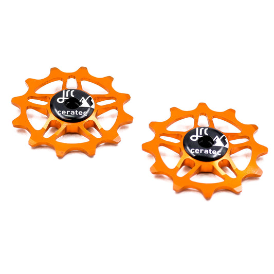 Orange, lightweight aluminium 12 tooth pulley wheel set for bicycles, compatible with SRAM Rival, Force and Red AXS